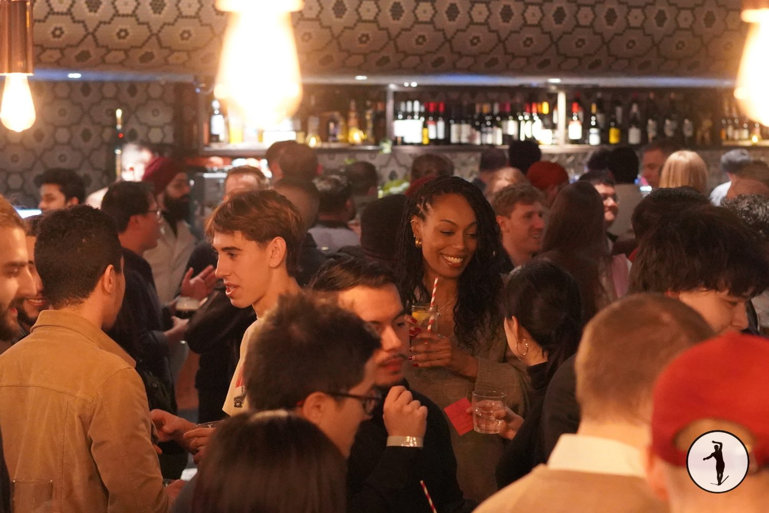 Guests mingling and talking in a busy Balancers venue